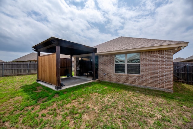 back of house featuring a yard