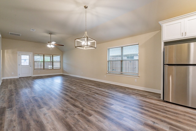 interior space featuring dark hardwood / wood-style flooring, vaulted ceiling, and ceiling fan with notable chandelier