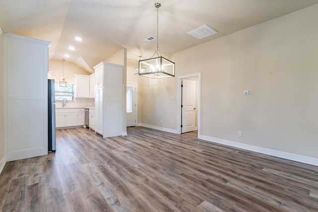 interior space with hardwood / wood-style floors, lofted ceiling, a chandelier, and sink