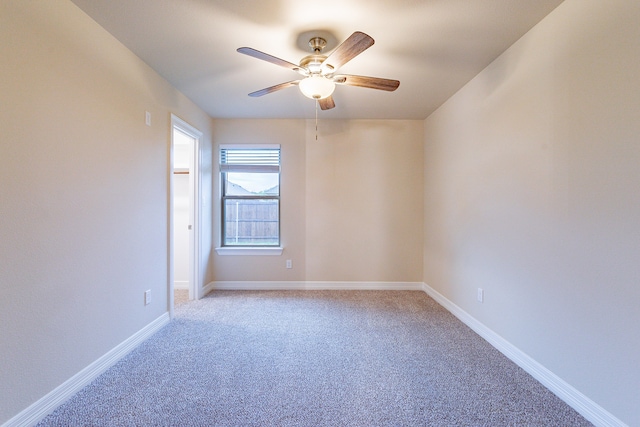 empty room with ceiling fan and light colored carpet