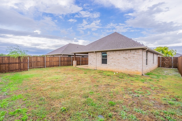 back of house with a yard