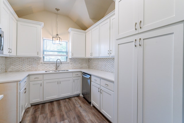 kitchen with lofted ceiling, dishwasher, white cabinets, sink, and decorative light fixtures