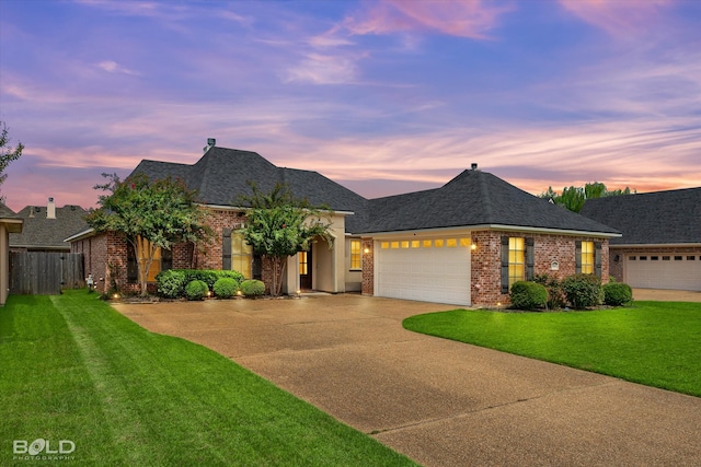 view of front of home featuring a garage and a yard