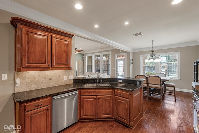 kitchen featuring sink, kitchen peninsula, ornamental molding, dark hardwood / wood-style floors, and stainless steel dishwasher