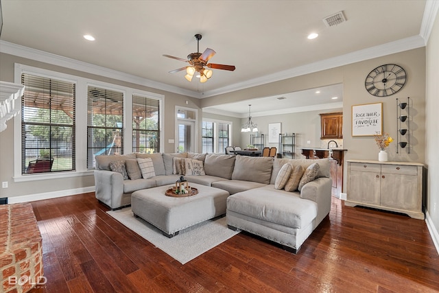 living room featuring ornamental molding, dark hardwood / wood-style flooring, and a healthy amount of sunlight