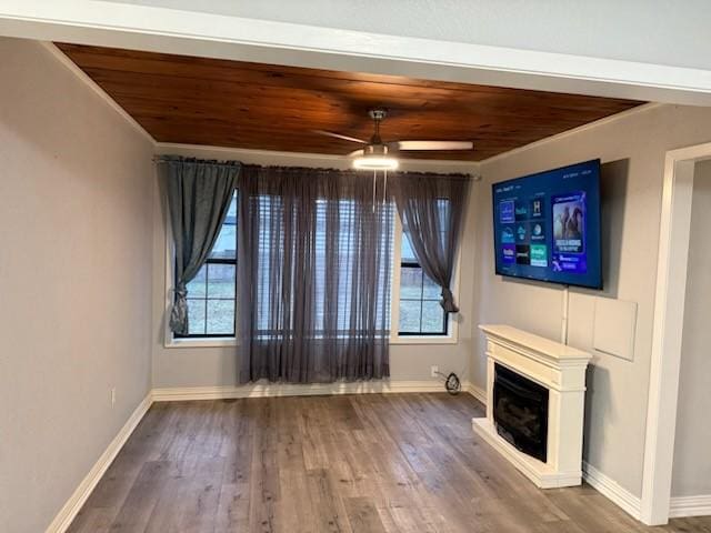 unfurnished living room with ceiling fan, a healthy amount of sunlight, and wood-type flooring