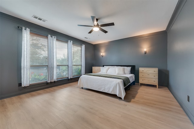 bedroom featuring ceiling fan, crown molding, and light wood-type flooring