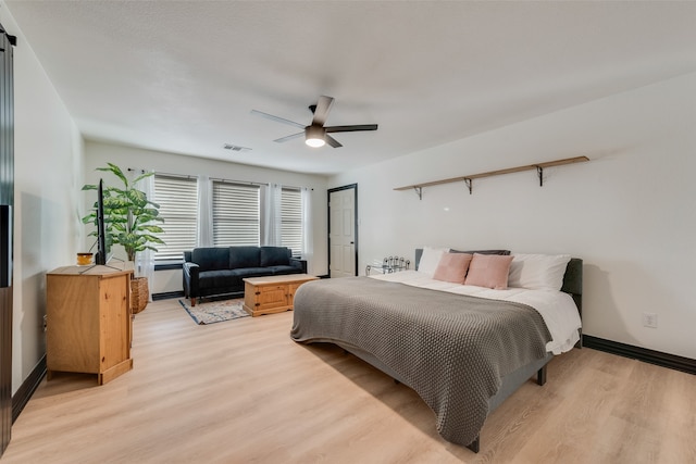 bedroom with ceiling fan and light hardwood / wood-style floors