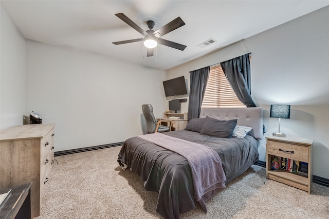 carpeted bedroom with ceiling fan and a baseboard radiator