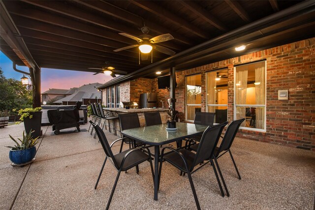 view of patio / terrace with ceiling fan and an outdoor kitchen