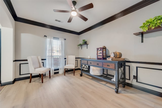 sitting room featuring ceiling fan, light hardwood / wood-style flooring, and crown molding