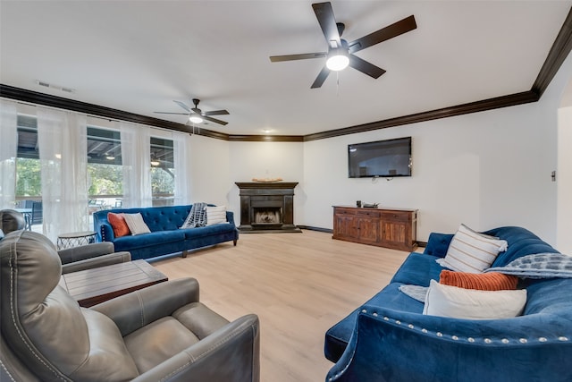 living room featuring hardwood / wood-style flooring, crown molding, and ceiling fan