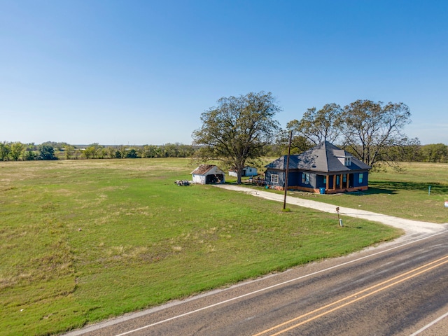 exterior space with a front yard and a rural view