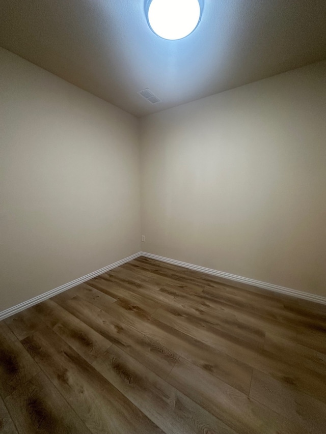 unfurnished room with hardwood / wood-style flooring