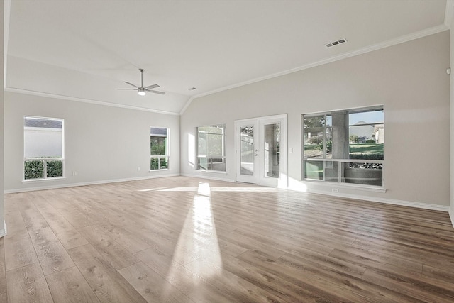 unfurnished living room with ceiling fan, light wood-type flooring, crown molding, and vaulted ceiling