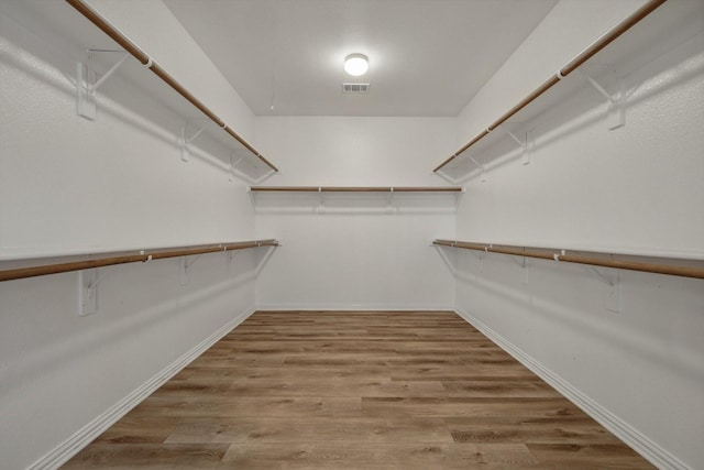 spacious closet featuring hardwood / wood-style floors