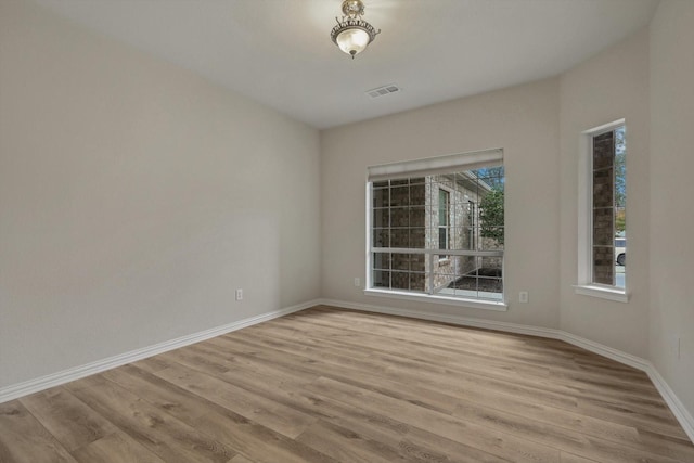 empty room with light hardwood / wood-style flooring