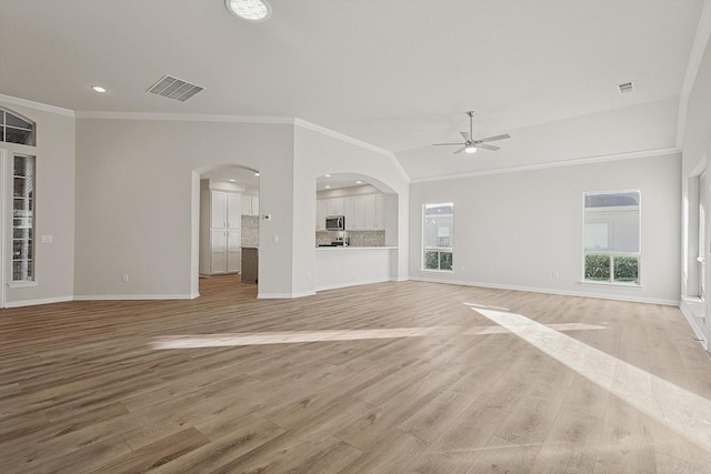 unfurnished living room with ceiling fan, crown molding, and light hardwood / wood-style flooring