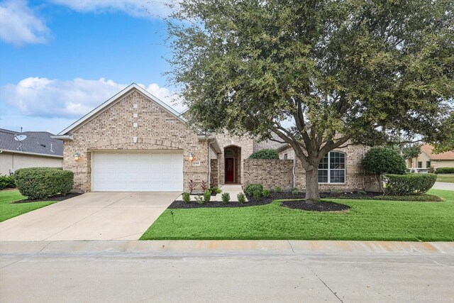 view of front of house featuring a garage and a front lawn