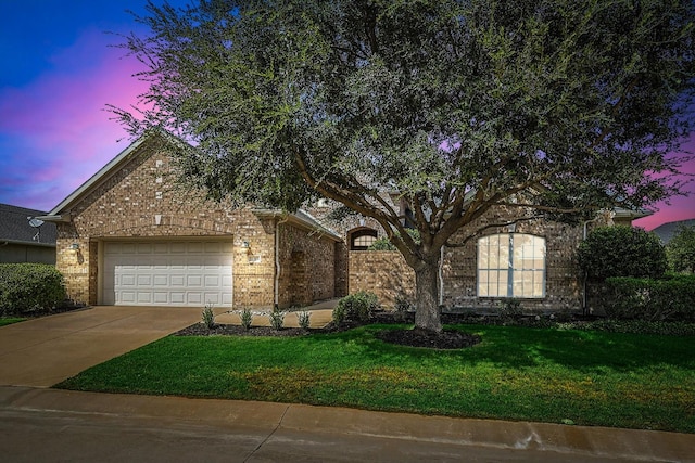 view of property hidden behind natural elements featuring a yard and a garage