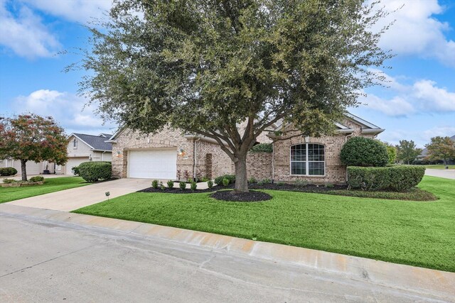 view of property hidden behind natural elements featuring a front yard