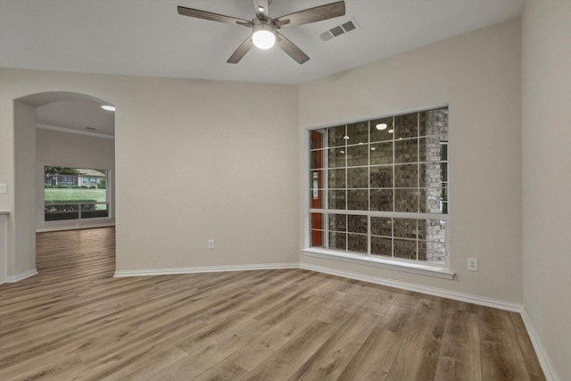 unfurnished room with ceiling fan, light hardwood / wood-style floors, and crown molding