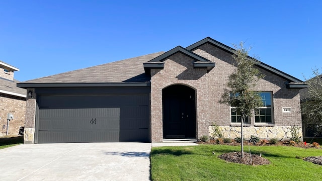 view of front facade with a front lawn and a garage