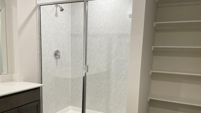 bathroom featuring vanity and an enclosed shower