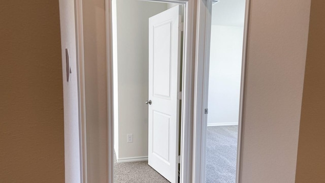 corridor with light carpet