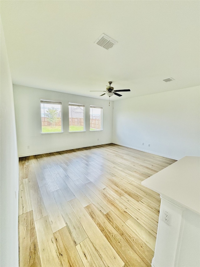 spare room with ceiling fan and light hardwood / wood-style floors