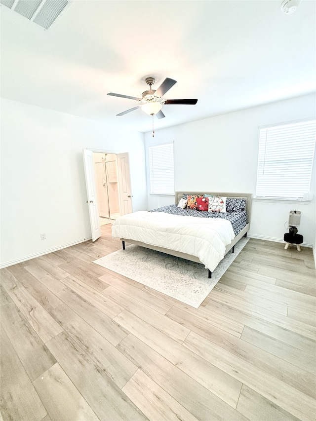 unfurnished bedroom featuring multiple windows, light hardwood / wood-style floors, and ceiling fan