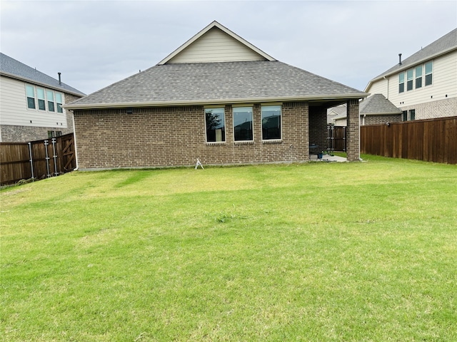 back of house with a yard