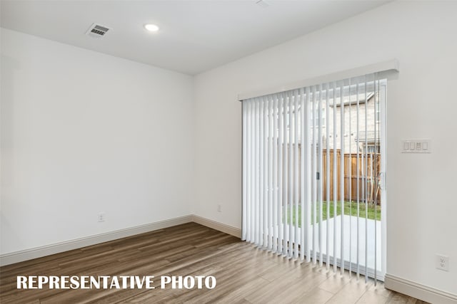 spare room featuring light wood-type flooring