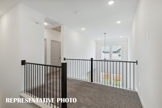 hallway with carpet floors