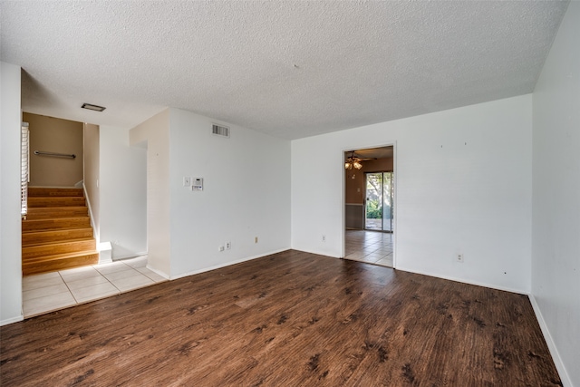 empty room with light hardwood / wood-style flooring, ceiling fan, and a textured ceiling