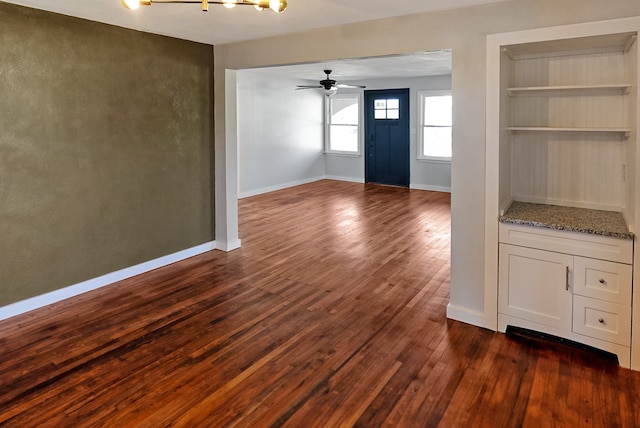 foyer entrance with ceiling fan and dark hardwood / wood-style flooring