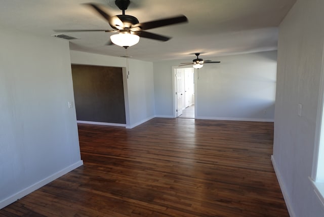 unfurnished room featuring dark hardwood / wood-style flooring and ceiling fan