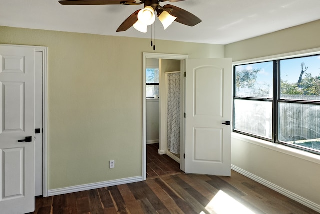 unfurnished bedroom featuring dark hardwood / wood-style floors and ceiling fan