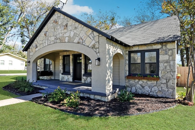 view of front of house with a porch and a front lawn