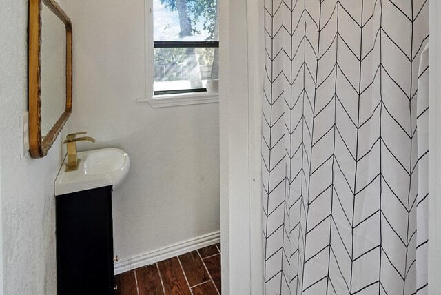 bathroom with hardwood / wood-style flooring, vanity, and a shower with shower curtain