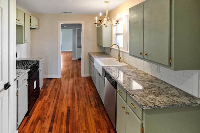 kitchen with sink, stainless steel dishwasher, light stone countertops, gas stove, and dark hardwood / wood-style flooring