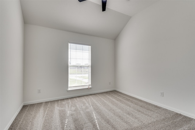 carpeted empty room featuring vaulted ceiling and ceiling fan