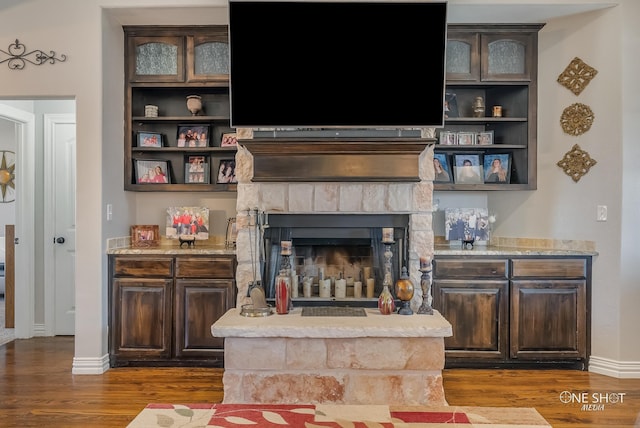 living room with a fireplace and dark wood-type flooring