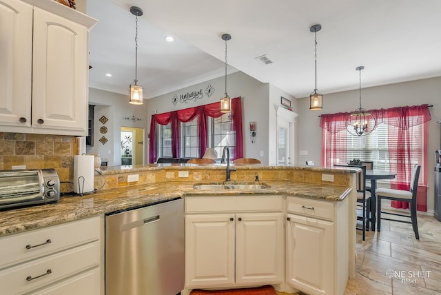 kitchen with tasteful backsplash, light stone counters, stainless steel dishwasher, sink, and a chandelier