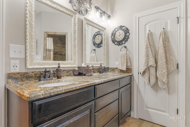 bathroom featuring tile patterned flooring and vanity