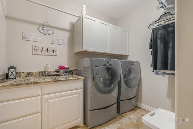 laundry area featuring washer and dryer and cabinets