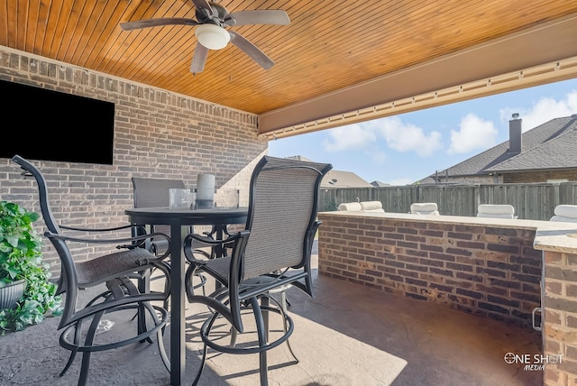 view of patio / terrace with ceiling fan and exterior bar