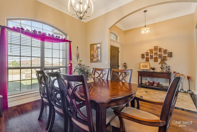 dining room featuring a chandelier, dark hardwood / wood-style floors, a wealth of natural light, and ornamental molding