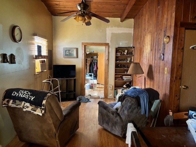 living room featuring ceiling fan, lofted ceiling with beams, wood ceiling, and wood-type flooring