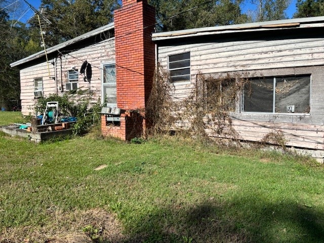 view of home's exterior with a lawn